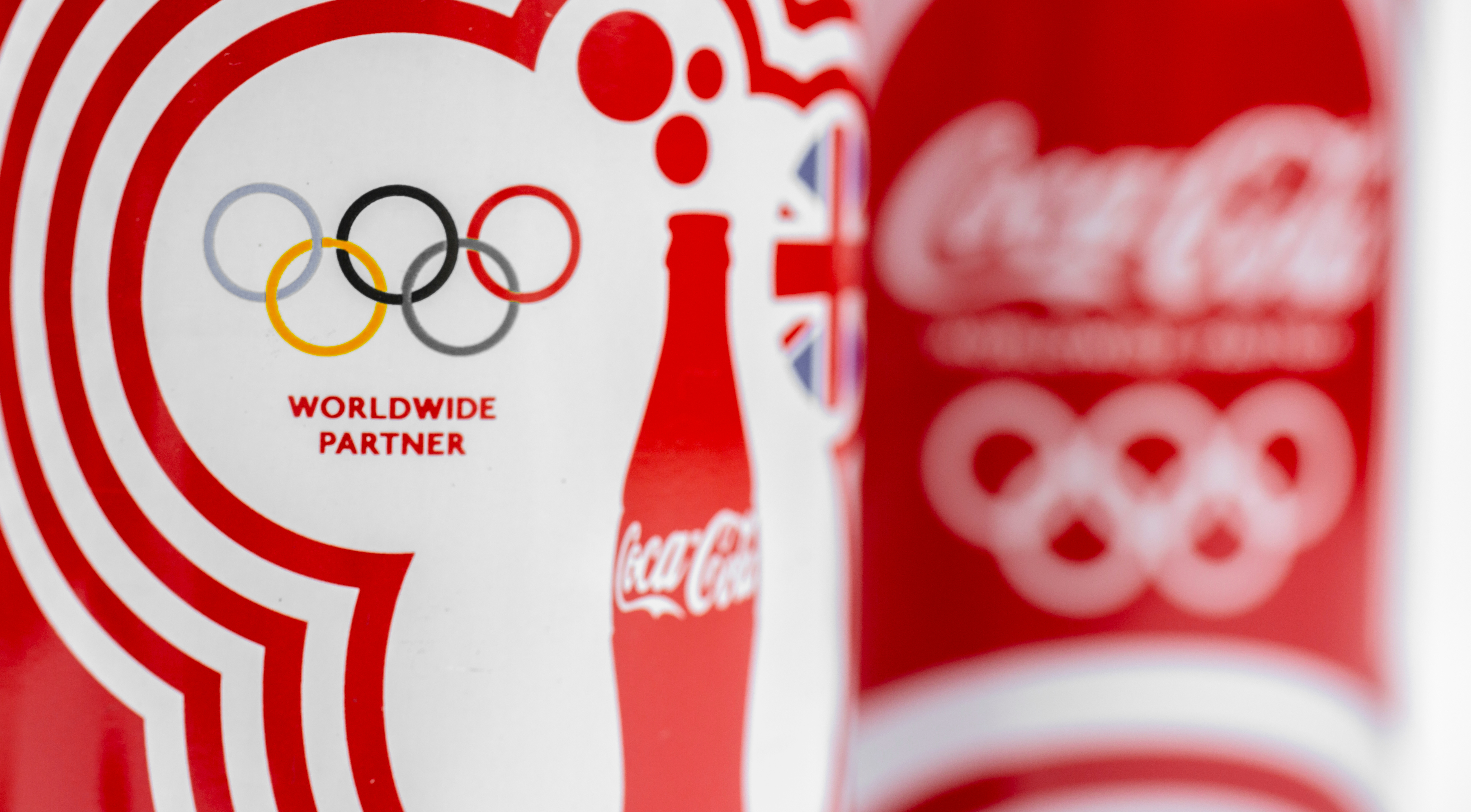 Two cans of Coca-Cola classic Limited Edition selective focus Olympic Games series isolated selective focus 