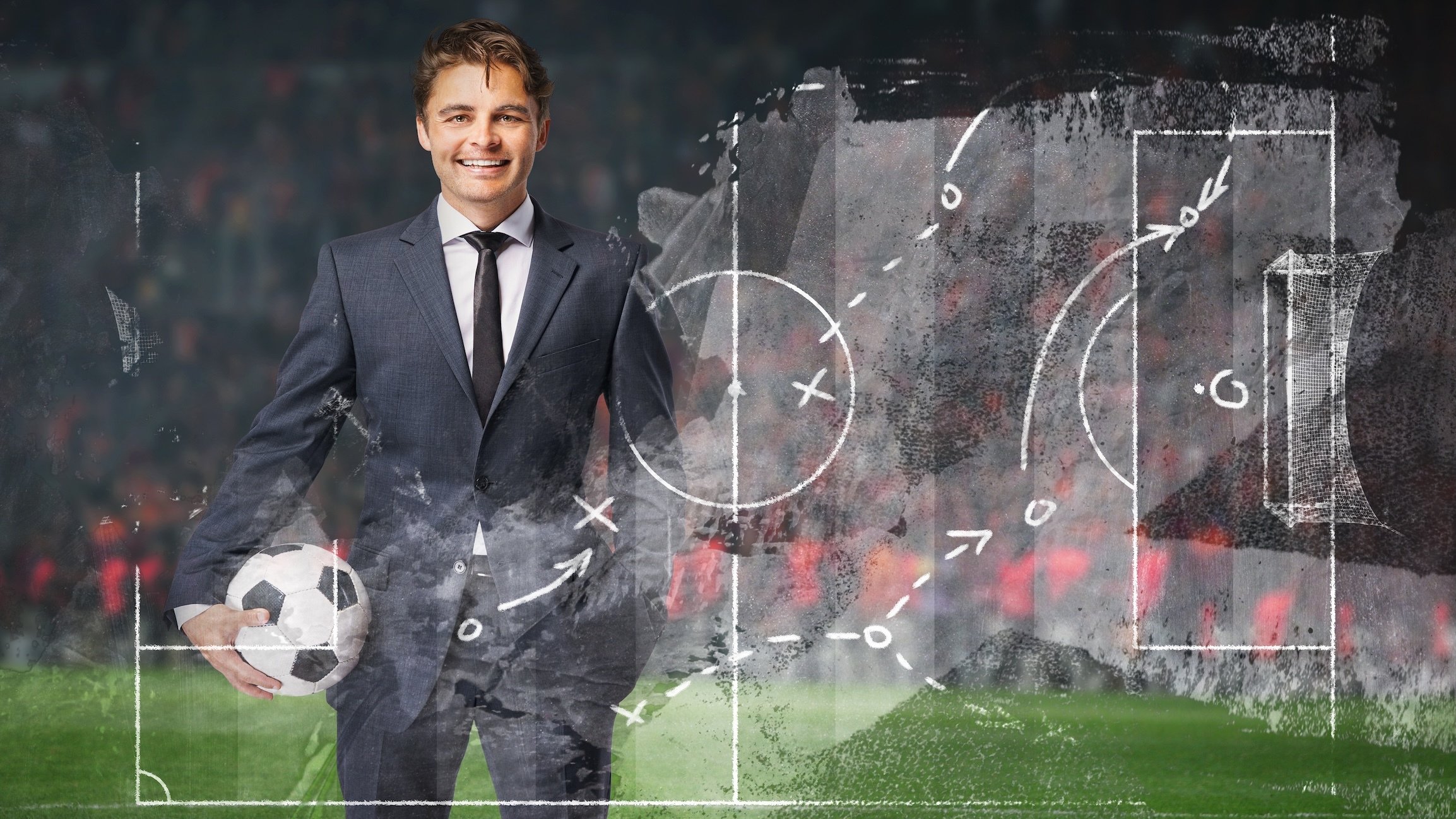 smiling businessman in formal wear with soccer ball in the big stage